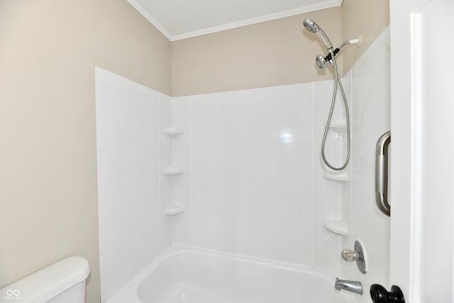 bathroom with toilet,  shower combination, and ornamental molding