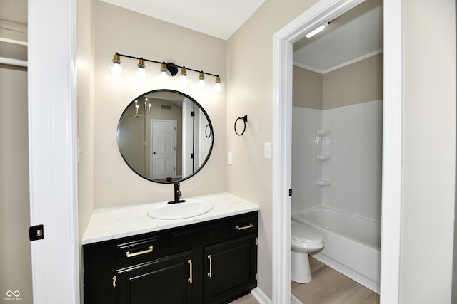bathroom with vanity, visible vents, wood finished floors, toilet, and shower / bathing tub combination