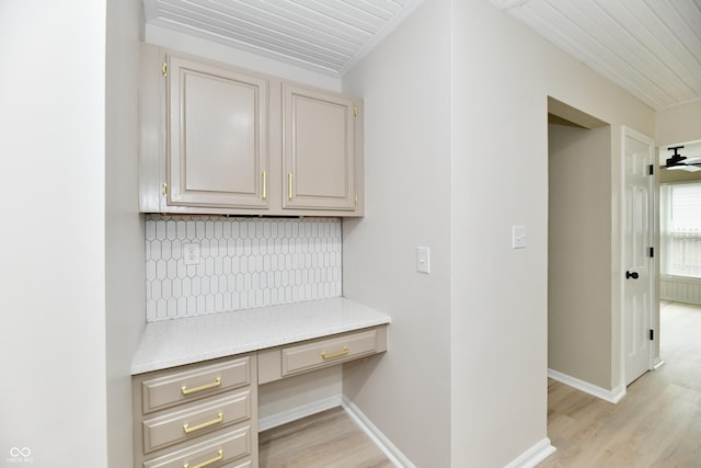 corridor featuring light wood-style floors and baseboards