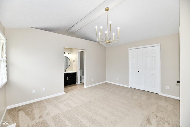 unfurnished bedroom with a closet, baseboards, light colored carpet, vaulted ceiling with beams, and a notable chandelier