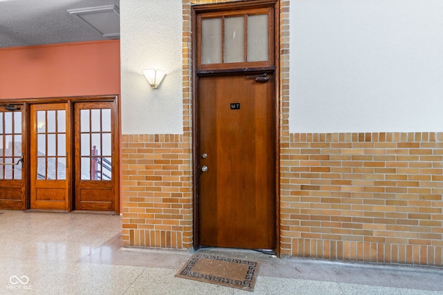 view of exterior entry featuring french doors