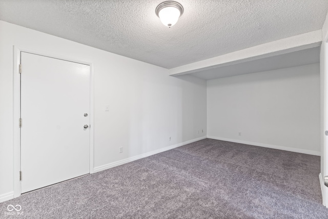 empty room featuring baseboards, carpet flooring, and a textured ceiling