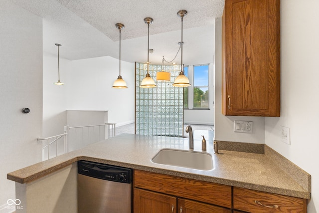 kitchen featuring brown cabinetry, a sink, dishwasher, and hanging light fixtures