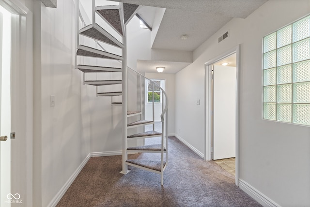 hall featuring stairway, carpet floors, baseboards, and visible vents