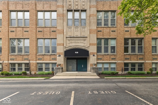 view of building exterior with uncovered parking