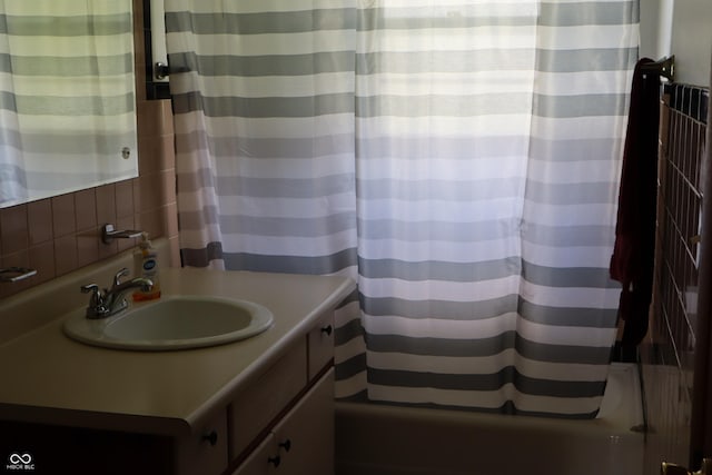 bathroom featuring vanity and shower / bathtub combination with curtain