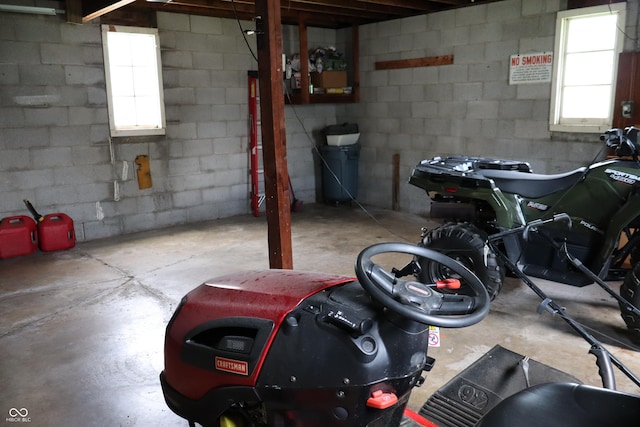 basement featuring concrete block wall and plenty of natural light