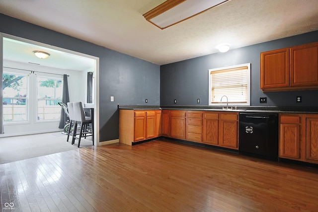 625 Maple St, Columbus, IN 47201 - kitchen featuring dishwasher, hardwood / wood-style floors, a sink, brown cabinetry, and dark countertops