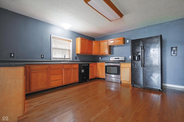 625 Maple St, Columbus, IN 47201 - kitchen with black appliances, dark wood-type flooring, a sink, and dark countertops