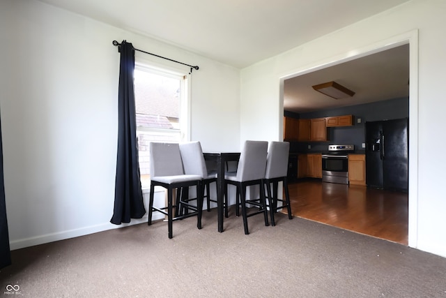 625 Maple St, Columbus, IN 47201 - dining space featuring dark carpet and baseboards