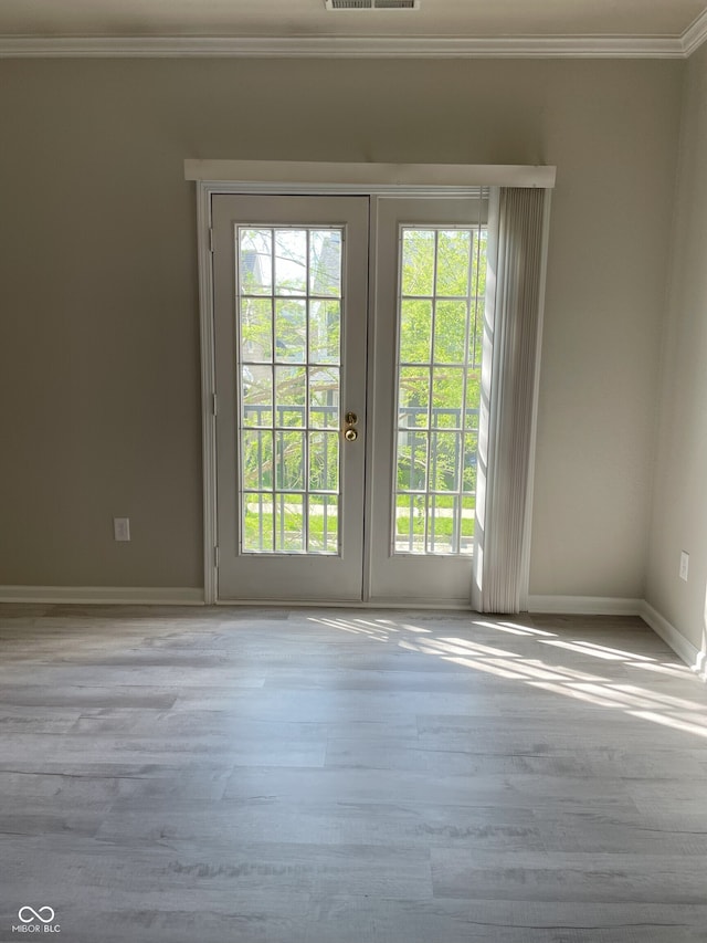 doorway to outside with french doors, visible vents, crown molding, wood finished floors, and baseboards