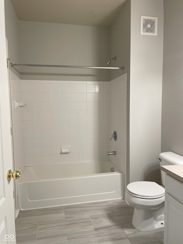 bathroom featuring vanity, toilet, shower / tub combination, and visible vents