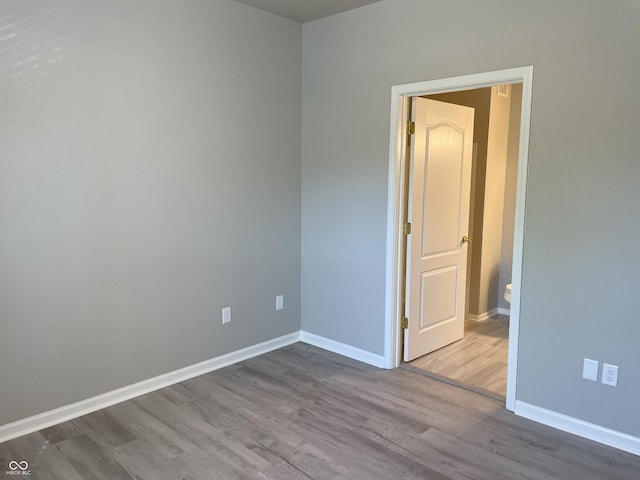 unfurnished room featuring baseboards and wood finished floors