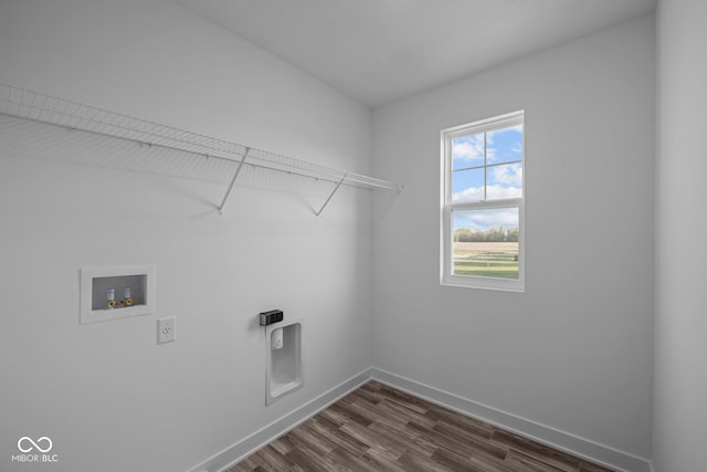 washroom featuring washer hookup, hookup for an electric dryer, laundry area, dark wood-style flooring, and baseboards