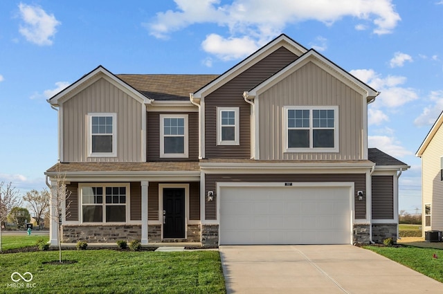 craftsman-style house featuring an attached garage, stone siding, board and batten siding, a front yard, and concrete driveway