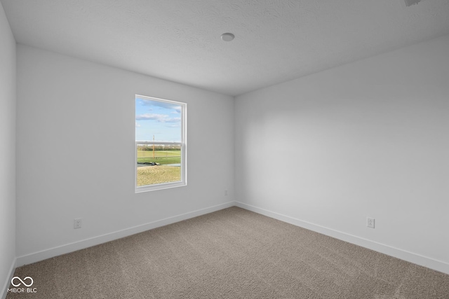 unfurnished room with carpet floors and baseboards