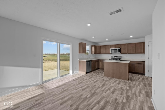 kitchen featuring visible vents, light countertops, light wood-type flooring, and stainless steel appliances
