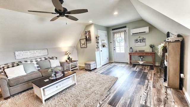 living area featuring a ceiling fan, vaulted ceiling, a wall mounted air conditioner, wood finished floors, and baseboards