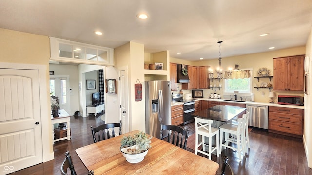dining area featuring dark wood-type flooring, recessed lighting, and a notable chandelier