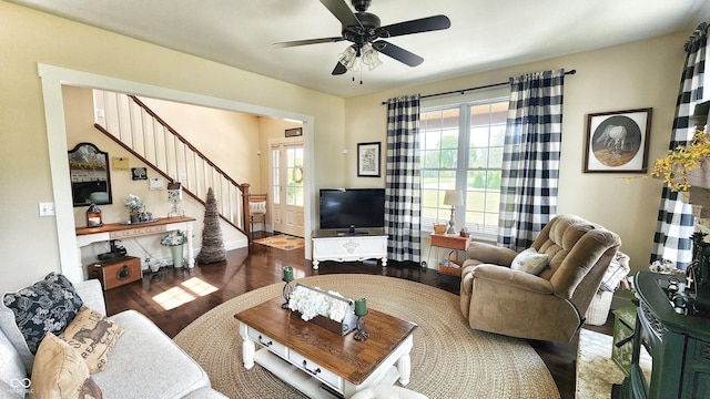 living room with a healthy amount of sunlight, stairway, a ceiling fan, and wood finished floors