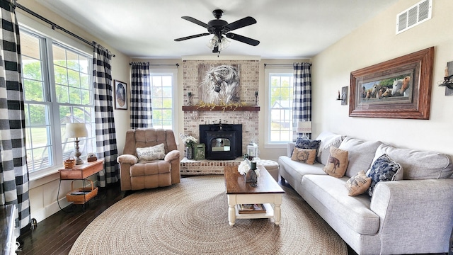 living area featuring a ceiling fan, wood finished floors, and visible vents