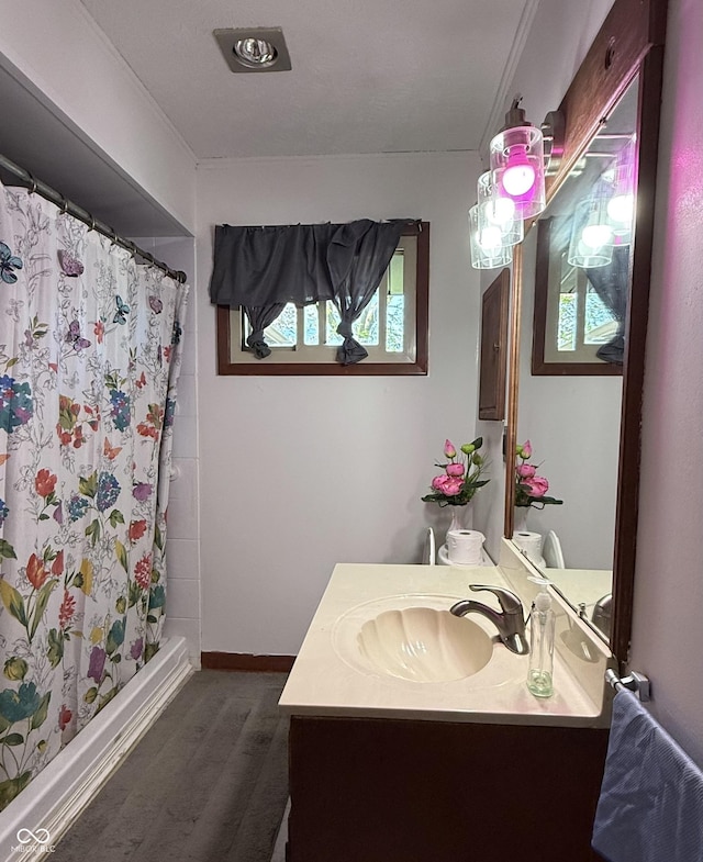 full bathroom with vanity, baseboards, and curtained shower