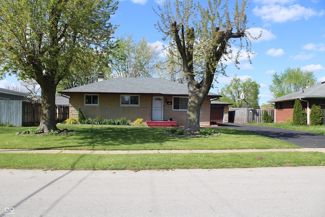 ranch-style home with fence, a chimney, and a front yard