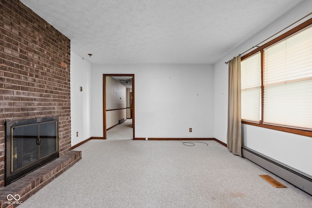 unfurnished living room with carpet flooring, a fireplace, a textured ceiling, baseboards, and a baseboard radiator