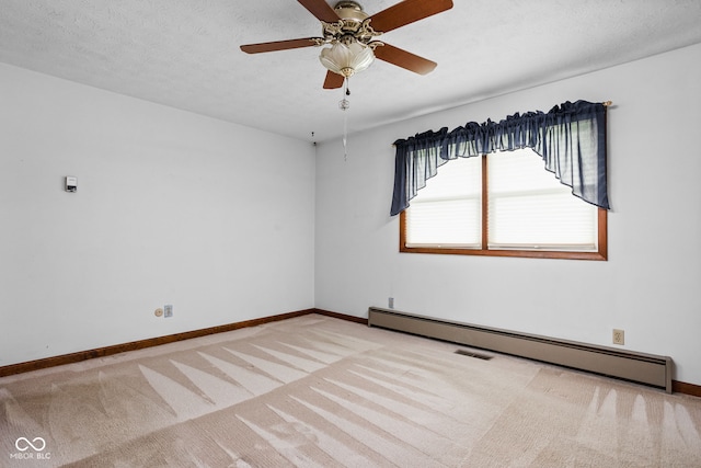 carpeted empty room with visible vents, baseboards, ceiling fan, baseboard heating, and a textured ceiling