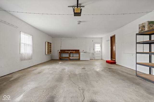 garage featuring a garage door opener and fridge