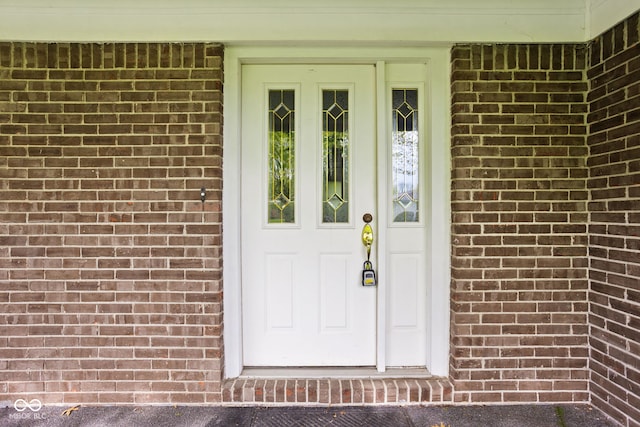 entrance to property with brick siding