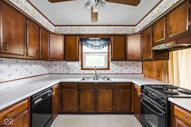 kitchen featuring a sink, light countertops, a ceiling fan, wallpapered walls, and black appliances