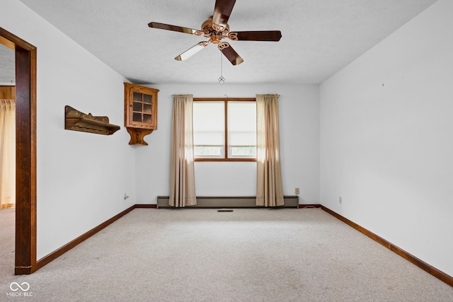 empty room featuring carpet floors, a ceiling fan, baseboards, and baseboard heating
