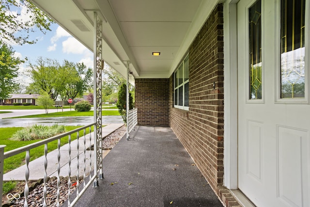 view of patio / terrace featuring a porch and visible vents
