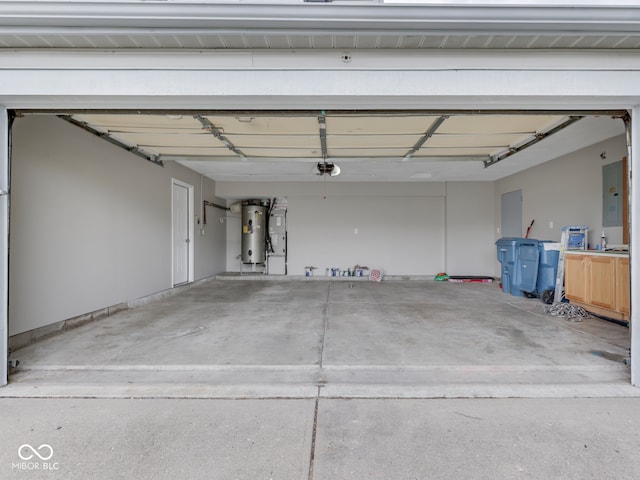 garage featuring a garage door opener, water heater, and electric panel