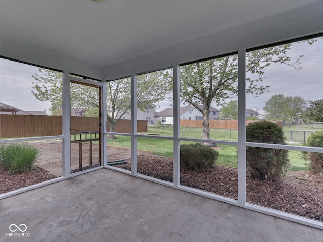 unfurnished sunroom with a residential view