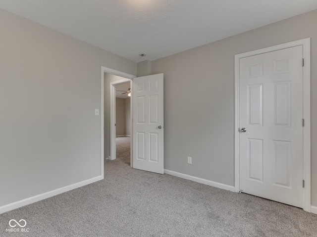 unfurnished bedroom with baseboards and carpet flooring