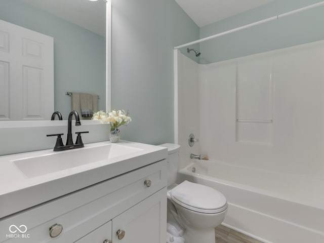 full bathroom with shower / bathtub combination, toilet, wood finished floors, and vanity