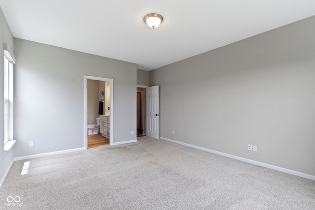 11595 Platt St, Noblesville, IN 46060 - unfurnished bedroom featuring light colored carpet, baseboards, and connected bathroom