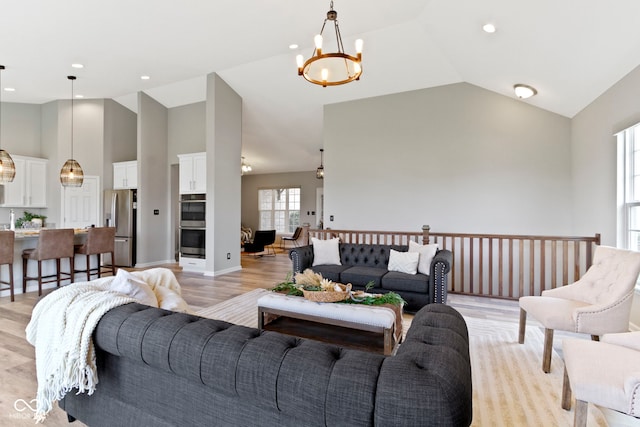 11595 Platt St, Noblesville, IN 46060 - living area featuring high vaulted ceiling, a chandelier, light wood-style floors, and recessed lighting