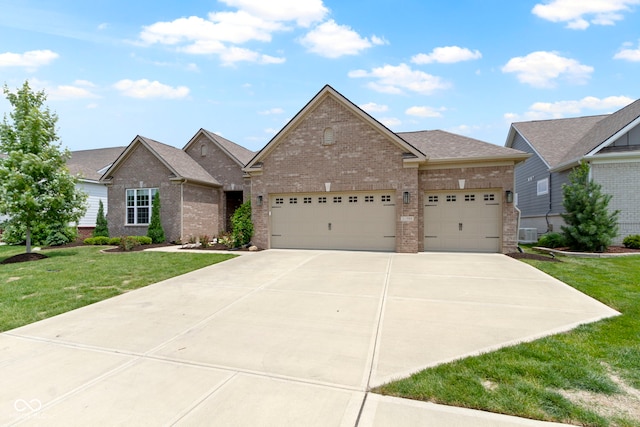 11595 Platt St, Noblesville, IN 46060 - view of front of home with brick siding, an attached garage, concrete driveway, and a front yard