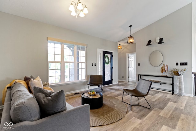 11595 Platt St, Noblesville, IN 46060 - living area with a chandelier, light wood-style flooring, baseboards, and high vaulted ceiling