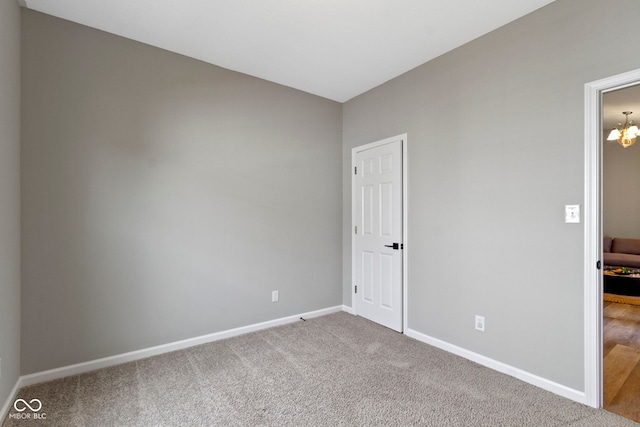 11595 Platt St, Noblesville, IN 46060 - unfurnished bedroom featuring baseboards, carpet, and a chandelier