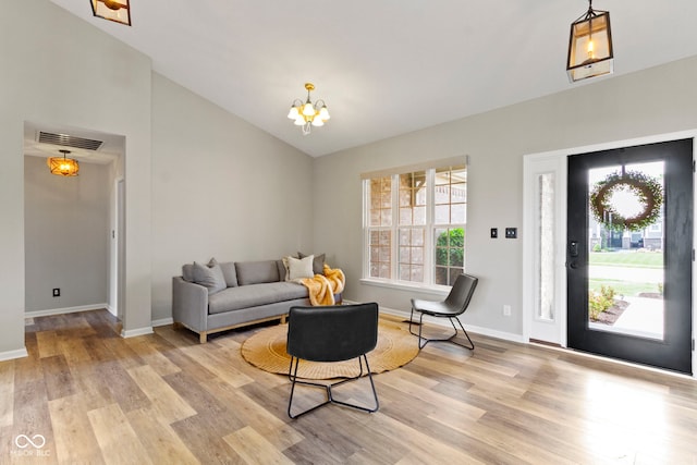 11595 Platt St, Noblesville, IN 46060 - living room with light wood-style floors, a chandelier, baseboards, and high vaulted ceiling