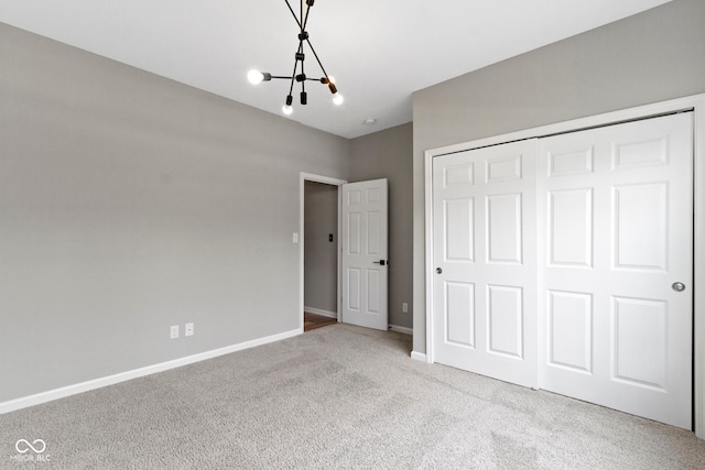 11595 Platt St, Noblesville, IN 46060 - unfurnished bedroom featuring a chandelier, carpet flooring, baseboards, and a closet