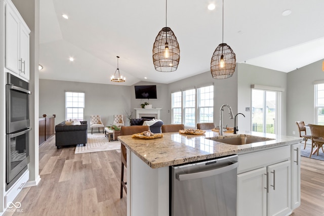 11595 Platt St, Noblesville, IN 46060 - kitchen with stainless steel appliances, lofted ceiling, a sink, light wood-style flooring, and an island with sink
