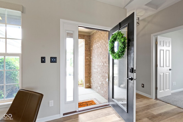 11595 Platt St, Noblesville, IN 46060 - entryway with wood finished floors, brick wall, and baseboards