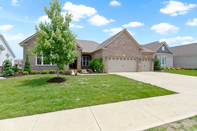 11595 Platt St, Noblesville, IN 46060 - view of front of house featuring brick siding, a garage, concrete driveway, and a front yard