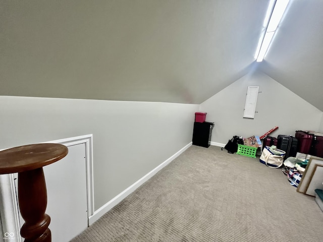 additional living space with carpet floors, baseboards, and vaulted ceiling