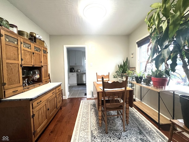 dining area featuring baseboards and dark wood-style floors